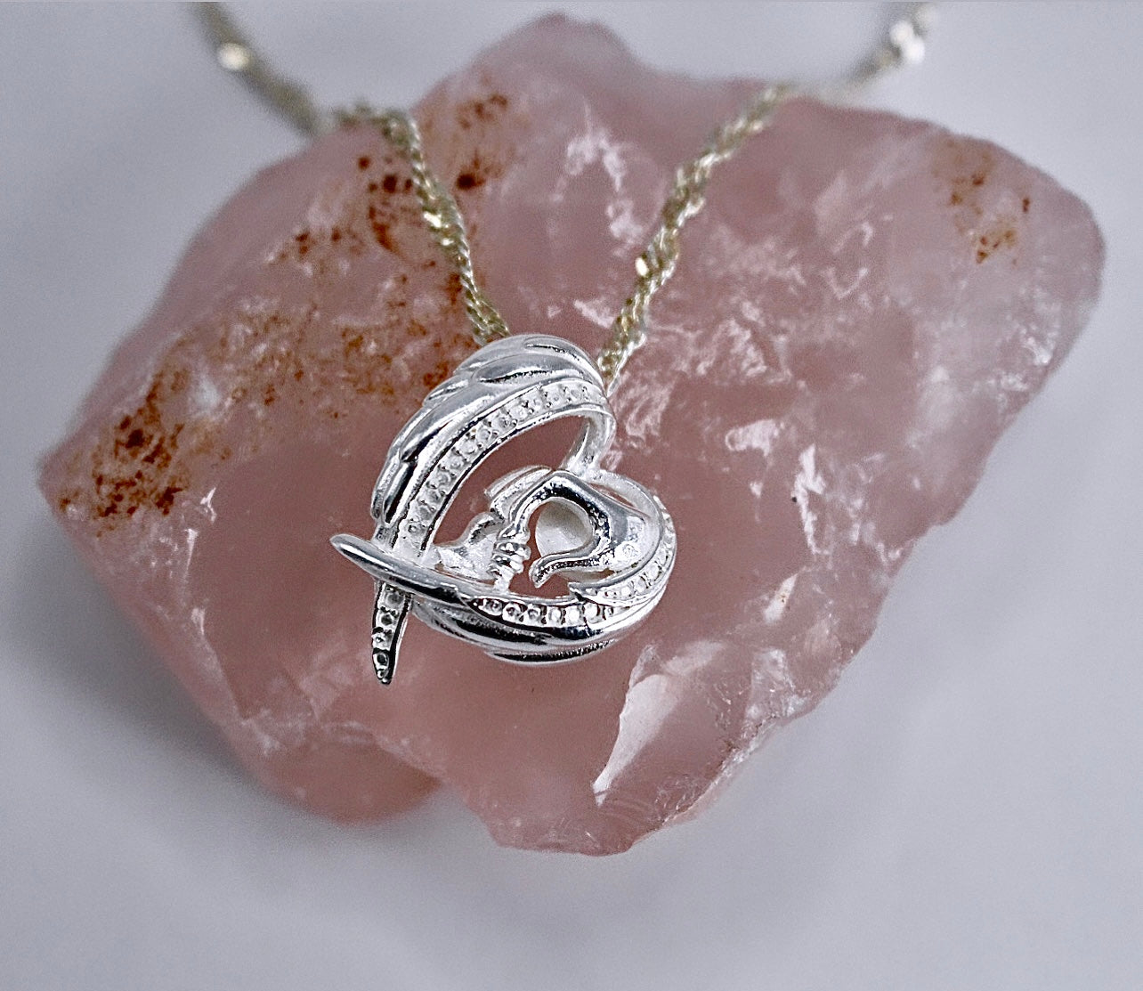 WINGS & MOM HOLDING BABIES HAND