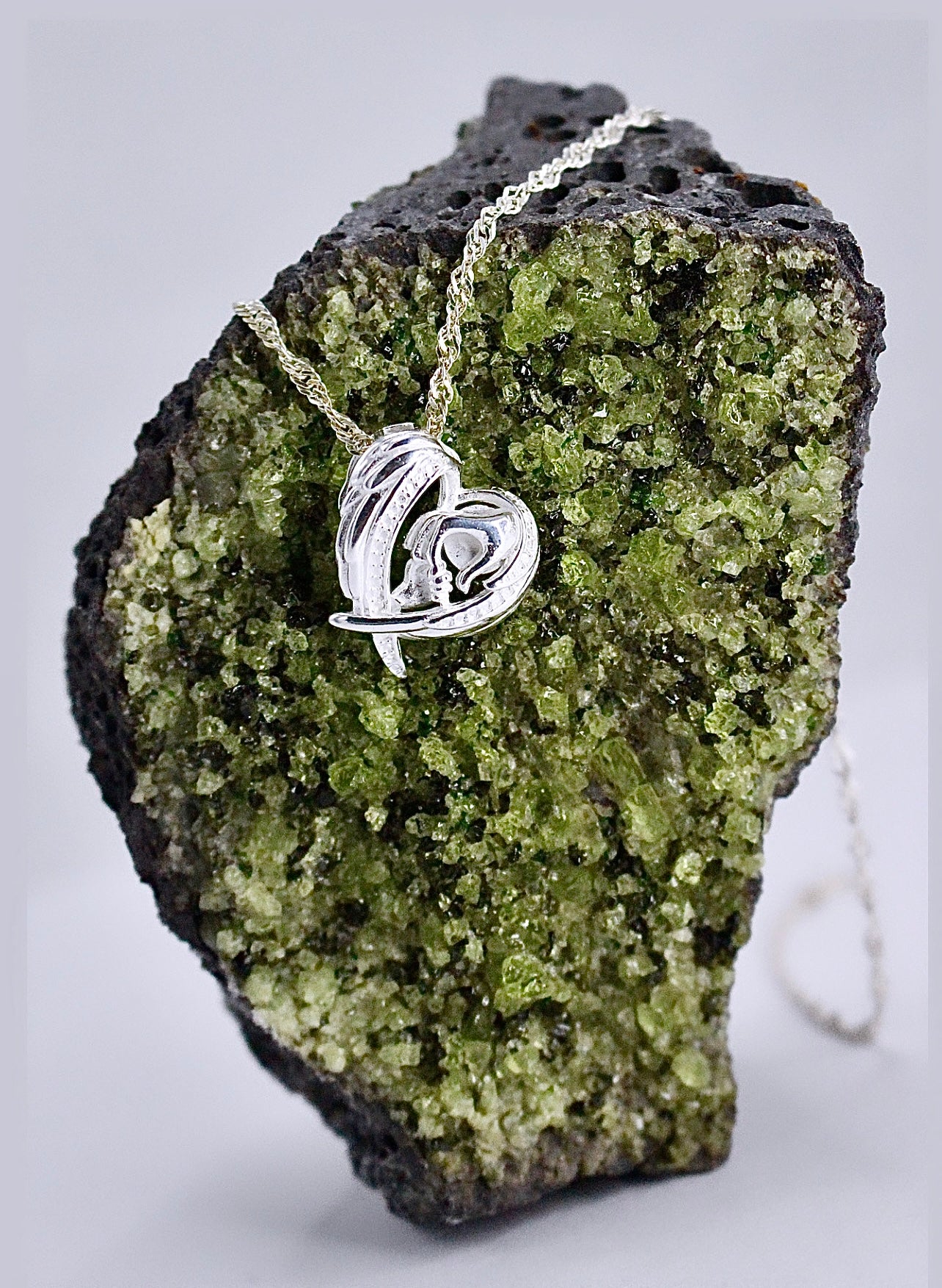 WINGS & MOM HOLDING BABIES HAND